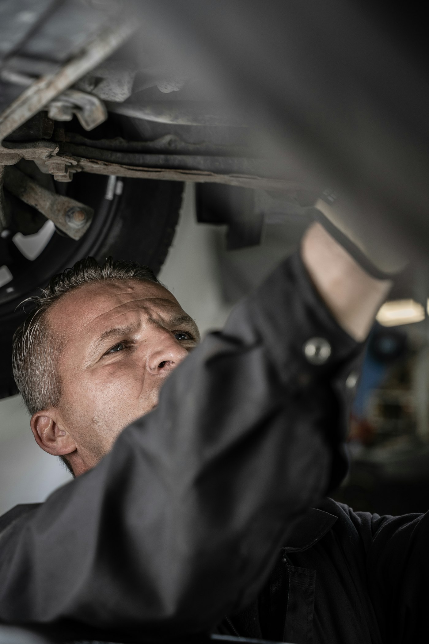 Certified Valvoline Oil Change technician inspecting a vehicle's undercarriage
