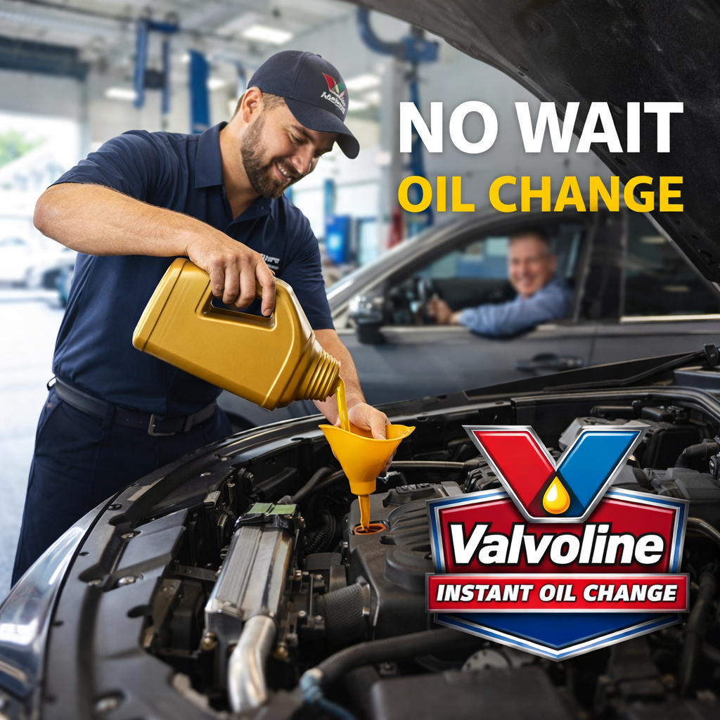 Mechanic performing an oil change service